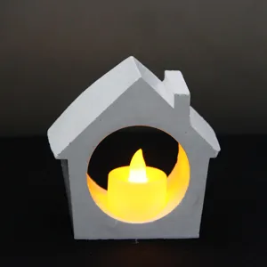 White concrete house tea light candle holder detail shot with warm LED light inside