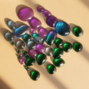 Close-up detail shot of colorful irregular resin gemstone cabochons, vibrant smooth stones.