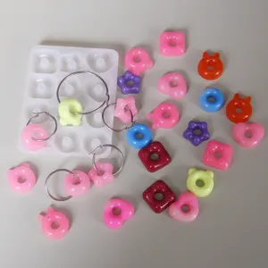 Cute crystal epoxy donut hoop earring mold set with cartoon charms for DIY jewelry making.
