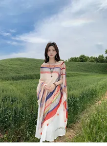 Outdoor detail view of a colorful striped shawl cape, perfect for summer beach and sun protection.