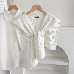 Elegant white knitted shawl paired with a classic shirt, ideal for stylish layering and spring outfits.