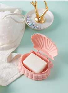 Vue détaillée du porte-savon rose portable en forme de coquillage avec design de drainage.