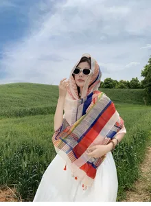 Close-up detail of colorful striped shawl showing lightweight fabric for summer beach travel.