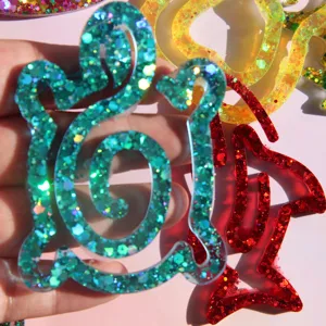 Detailed view of handmade epoxy resin glitter bookmarks in cute animal shapes, glossy finish.