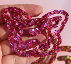 Pink glitter butterfly resin bookmark detail showing sparkly finish and cutout heart design.