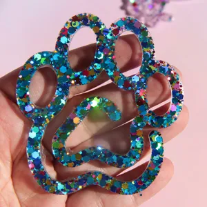 Blue glitter cat paw resin craft detail shot, sparkling epoxy keychain accessory display.