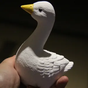 Handmade white goose figurine detail shot, showing textured 3D animal ornament mold design clearly.