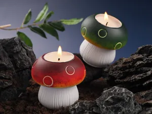 Mushroom scented candle detail view, unique red and green mushroom shaped design for home decor.