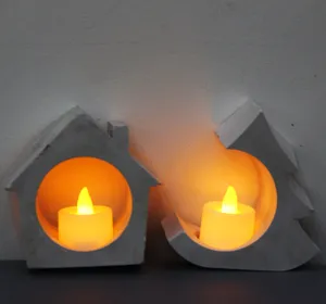 Concrete house and tree candle holder set with warm LED tea light for home decor.