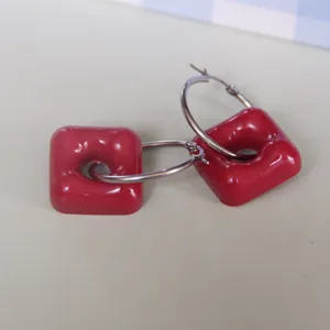 Chic red geometric hoop earrings with hollow square resin charm, fashionable daily wear jewelry.
