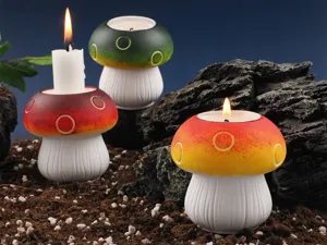 Detailed view of colorful mushroom shaped candle holders placed on soil.