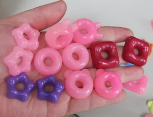 Cute resin donut and star charm pendant detail view showcasing various colorful shapes.