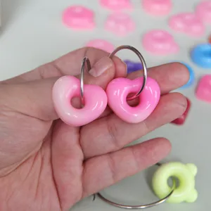 Cute pink heart donut resin charms with metal loops, perfect for DIY jewelry making and crafts.