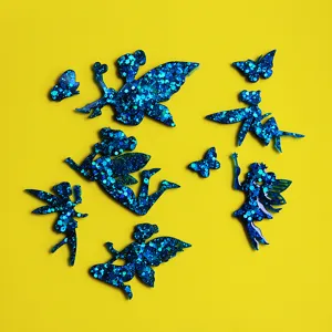 Blue glitter resin fairy and butterfly charms accessories close up product details view.