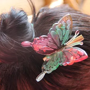 Beautiful resin butterfly hair clip with colorful gradient and gold foil for women and girls.