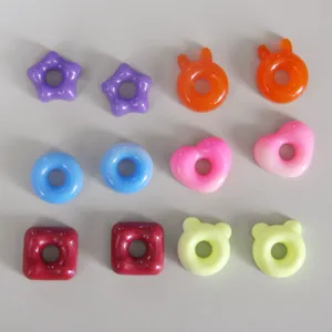 Detailed close-up of colorful resin donut pendant molds, featuring cute star, heart, and bear shapes.