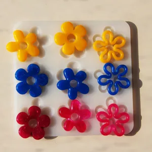 DIY crystal epoxy flower mold set with colorful resin pendant charms for handmade crafts.
