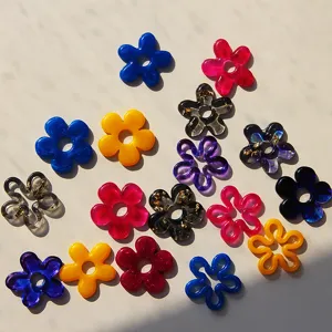 Close-up detail of colorful resin flower pendants, glossy surface with exquisite gold foil.