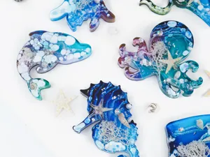 Close-up of handmade resin ocean animal charms featuring dolphin, octopus, and seahorse.