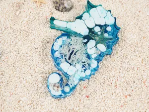 DIY epoxy resin seahorse mold ocean style decorative craft with natural shell stone detail.