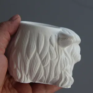 Handmade white highland yak shaped pen holder and candle cup silicone mold for casting.