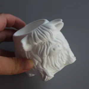 Highland cow shaped white container detail view, suitable for pen holder and candle jar.