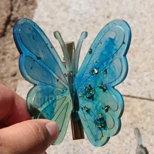Blue resin butterfly hair clip with gold foil flakes, elegant hair accessory for women.