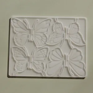 Detailed close-up view of the 4-cavity 3D butterfly silicone mold for DIY resin hairpins.