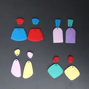 Close-up detail of colorful geometric DIY earring pendants and resin molds in various shapes.