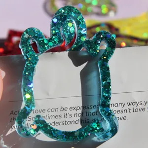 Green glitter resin bookmark paperclip detail view, cute animal shape crafted for reading lovers.