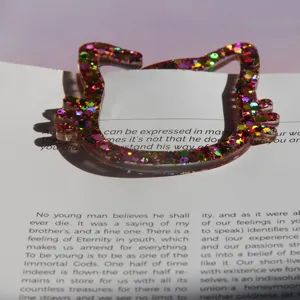 Cute glitter resin cat head bookmark and paperclip, shiny decorative stationery item.