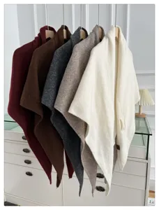 Details of the solid color wool blend triangle shawl, stylish draped winter scarf accessory.