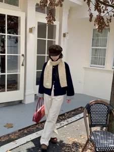 Detailed view of a cozy beige cable knit winter scarf, styled for casual daily wear and warmth.
