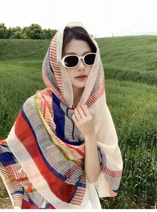 Outdoor detail view of the colorful geometric patterned thin sunscreen silk scarf shawl.