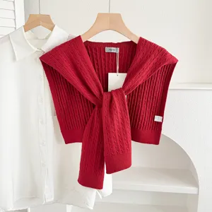Red knit shawl accessory, cable knit design, ideal for layering over shirts and sweaters.