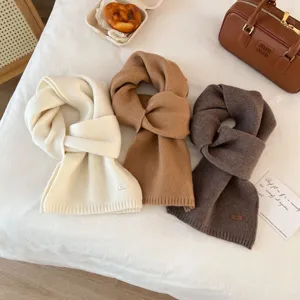 Detailed close-up of thick winter knit woolen scarf in solid colors, soft warm texture.