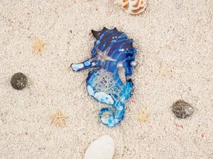 Epoxy resin marine seahorse craft detail showcasing blue ocean texture, tiny shells and starfishes.