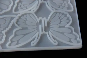 Detailed view of butterfly silicone mold, translucent DIY resin craft tool for hair clip making.