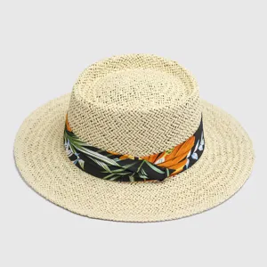 Detailed view of beige straw flat top hat with floral ribbon, wide brim summer sun hat.