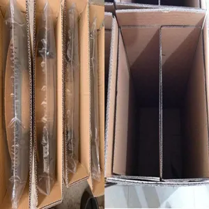 Detail view of protective partitioned cardboard boxes and plastic packaging for hats.