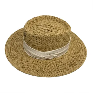 Womens flat top straw hat with wide brim and elegant ribbon band for summer outdoor sun protection.