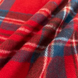 Detailed shot of a classic red and blue plaid scarf fabric, showcasing soft winter texture.
