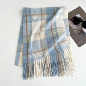 Cozy winter plaid scarf for women, elegant blue and white design with soft tassels. Ideal warm accessory.