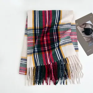 Detailed view of the colorful plaid winter scarf with cozy fringe texture and warm tartan pattern.