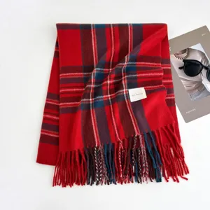 Classic red plaid winter scarf for women, cozy tartan shawl with chic fringe and soft fabric.