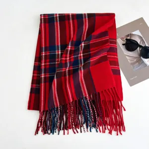 Classic red plaid winter scarf with fringe trim, cozy and warm fashion accessory for women.