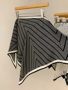 Detailed view of the black and white geometric stripe silk scarf, elegant texture for daily wear.