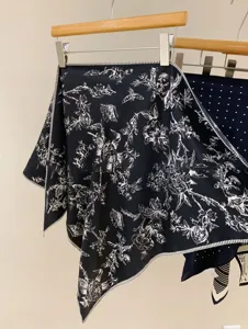 Detailed view of a chic black floral print silk scarf, featuring elegant vintage botanical design.