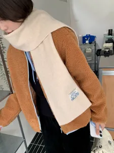 Cozy beige knitted scarf paired with a brown fleece jacket for ultimate winter warmth and style.