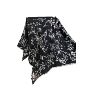 Chic black and white vintage floral print triangular silk scarf, elegant fashion hair accessory.